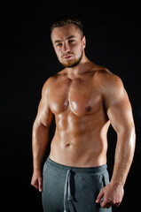 Fototapeta premium Young handsome guy on a diet. A man with a beautiful athletic body. 