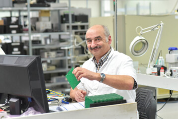 portrait of a worker in the engineering department of a factory for the production and construction of electronics