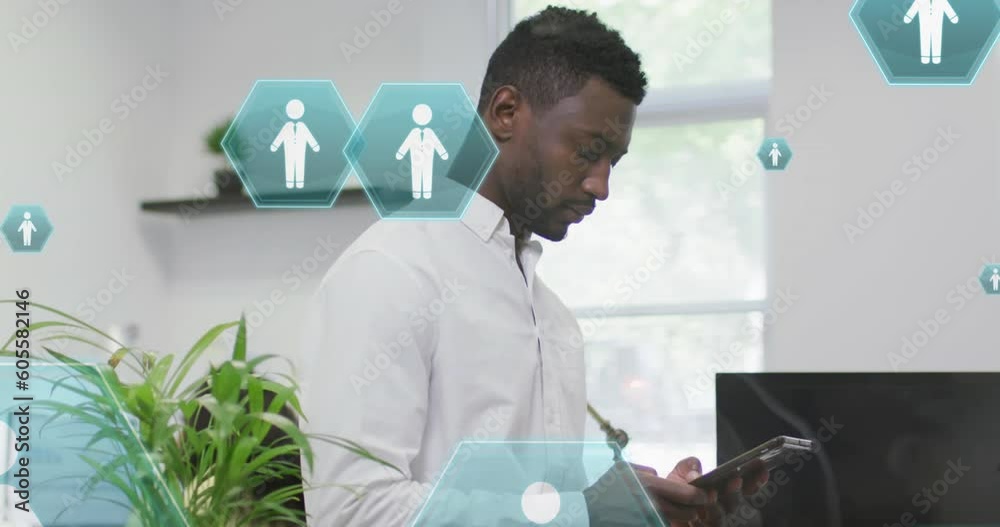 Wall mural Animation of profile icons floating against african american man using digital tablet at office