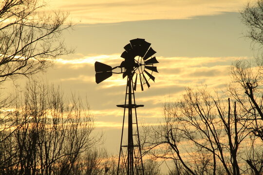 windmill silhouette at sunset with clouds