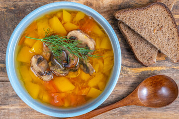 Bowl of Pumpkin Mushroom Soup on wooden background.