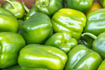 Fototapeta na wymiar Green Bell peppers at the market. Food background.