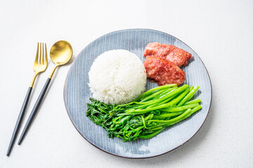 Chinese style meal for one with rice, steamed pork and stir-fried vegetables