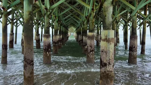 Ocean Waves crashing under the Apache Pier in Myrtle Beach South Carolina.