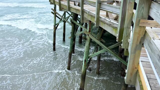 Waves crashing against the Apache Pier in Myrtle Beach South Carolina.
