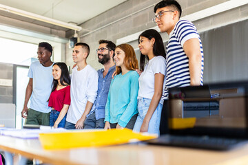 High school student friends posing together with male teacher for a group classroom photo the last...