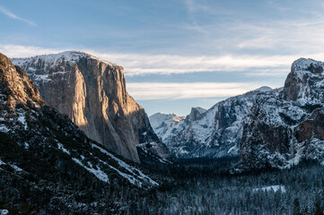 The first rays of the morning sun reflect off the rocks of the Sierra mountains in Yosemite national park, on a snow-covered new years day.