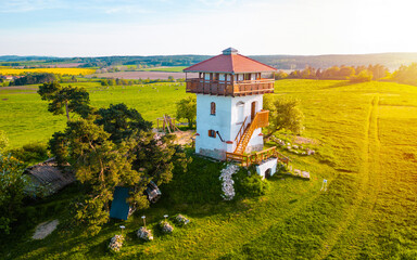 Experience the enchantment of sunset on lookout Tower in Czech Republic with this captivating photo. Illuminating the rolling hills and lush forests, a sense of tranquility and awe fills the air