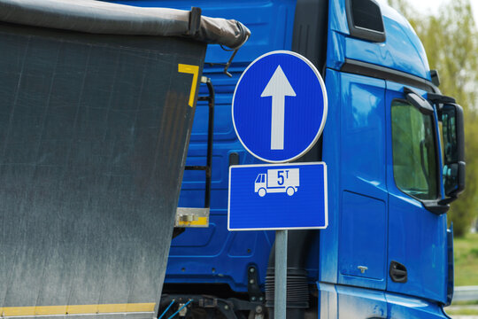 Obligatory direction traffic sign for heavy truck vehicles over five tons, european blue circle signage with white arrow