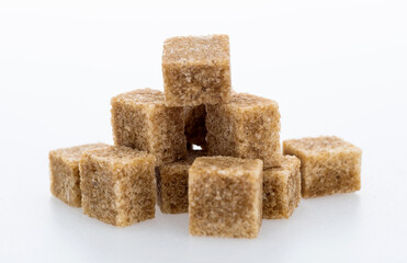 pile of brown sugar cube on white background