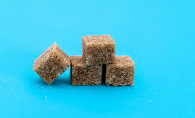 Brown sugar cubes on white background