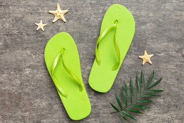 Flat lay composition with flip flops and seashell on colored background. Space for text top view