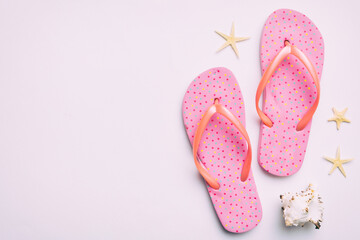 Flat lay composition with flip flops and seashell on colored background. Space for text top view