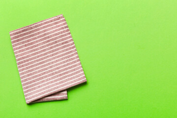 top view with red empty kitchen napkin isolated on table background. Folded cloth for mockup with copy space, Flat lay. Minimal style