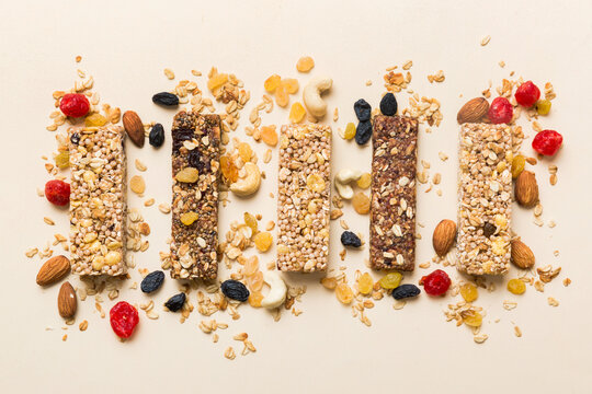 Various granola bars on table background. Cereal granola bars. Superfood breakfast bars with oats, nuts and berries, close up. Superfood concept