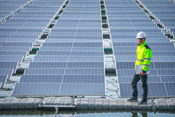 Portrait of professional man engineer working checking the panels at solar energy on buoy floating. Power plant with water, renewable energy source. Eco technology for electric power in industry.