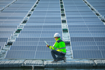 Portrait of professional man engineer working checking the panels at solar energy on buoy floating. Power plant with water, renewable energy source. Eco technology for electric power in industry.