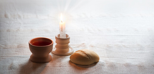 A bowl of wine and bread on the table. Communion symbols