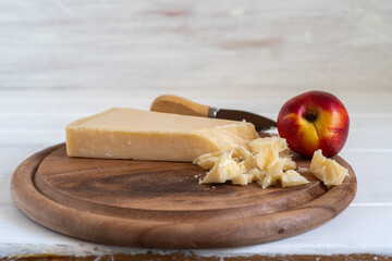 Parmesan cheese on wooden background.