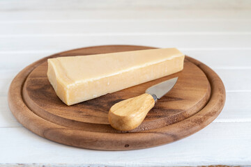 Parmesan cheese on wooden background.