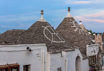 Fototapeta na wymiar Alberobello, Puglia, Italy: Typical houses built with dry stone walls and conical roofs, in a beautiful day, Apulia