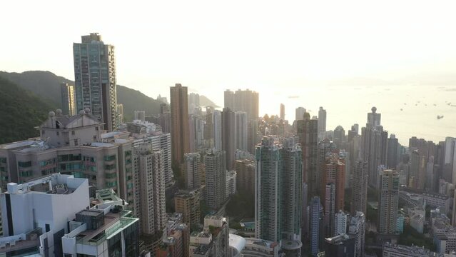 Aerial view Sunrise of Hong Kong cityscape with modern building and architecture and sunflares 4K stock video. 