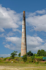 Fototapeta na wymiar 21st October, 2022, Kaikhali, West Bengal, India: An abandoned chimney at brick factory at a village of West Bengal.