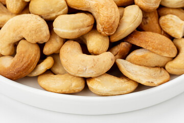Dried cashew nuts. Macro shot. Raw snack. Pile cashew nuts without shell. Whole nut kernels