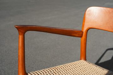 A danish mid century modern teak armchair from the 60s vintage standing in the dining living room...