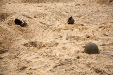 Three American infantry helmets M1 from the Second World War  on the beach. 