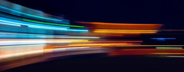 Abstract Rainbow light trails on the dark background