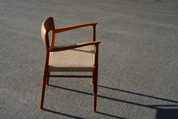 A danish mid century modern teak armchair from the 60s vintage standing in the dining living room...