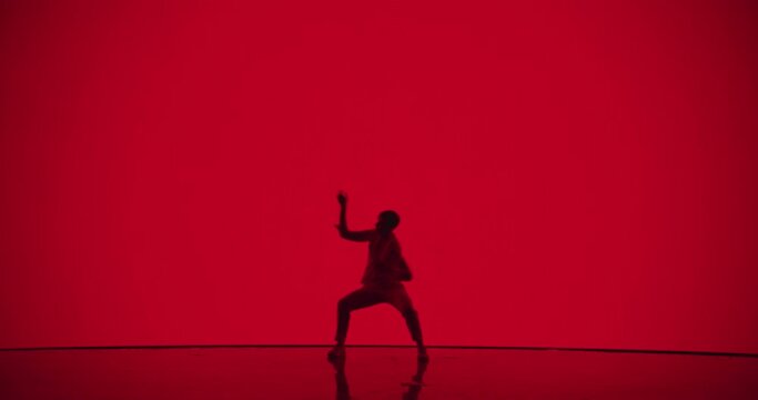 Skillful Male Dancer in White Costume Pushing the Boundaries of Movement, Delivering an Electrifying Abstract Performance with Modern Dance Elements, Spiraling Turns, and Exquisite Precision