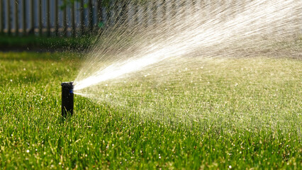 Automatic garden irrigation system watering lawn. Savings of water from sprinkler irrigation system...