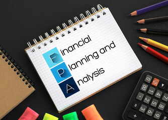 FPA - Financial Planning and Analysis acronym on notepad, business concept background