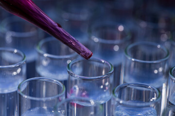 Pipette dropping fluid into test tube