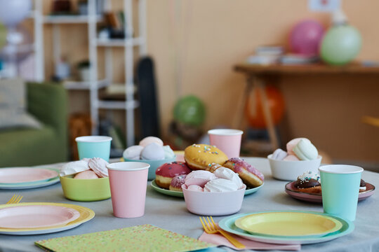 Background image of table with sweets and donuts at kids party, copy space