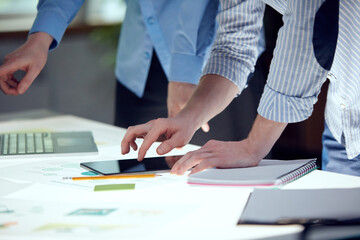 Collaborative process of skilled students during brainstorming meeting in office. Team of young people dressed in formal wear cooperating on developing common design project