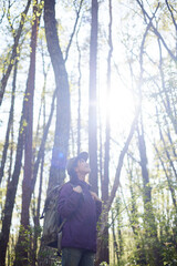 Fototapeta na wymiar 休日の初夏の森でハイキングを楽しむ30代日本人女性