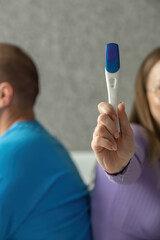 Negative pregnancy test in the hands of a young woman. Conscious denial of pregnancy, childfree. selective focus