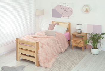 Teenager's room interior with stylish furniture and beautiful decor elements