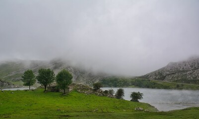 Naklejka na ściany i meble Beautiful landscape of a lake in rocky mountains on a cloudy day