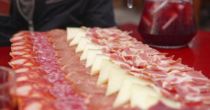 Board Of Iberian Ham And Cheese On The Table. - closeup