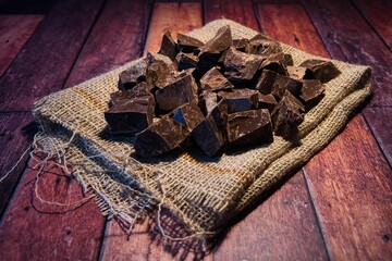 Closeup of chocolate on a sack on a wooden surface
