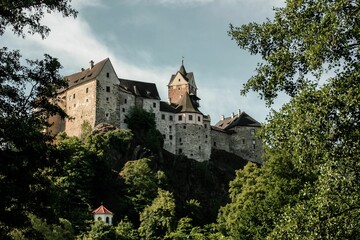 Fototapeta na wymiar Beautiful Loket Castle in Czechia surrounded by green lush trees