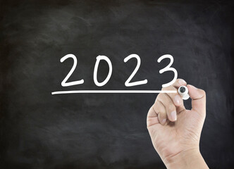 Year 2023 wording with handwriting on black board