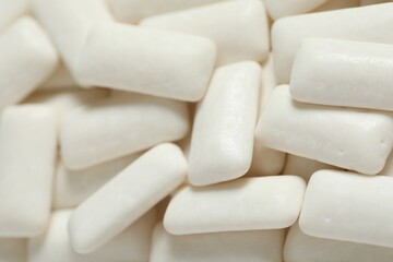 Fototapeta na wymiar Tasty white chewing gums as background, closeup