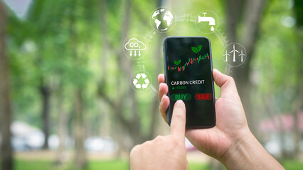 Businessman using smartphone to exchange carbon credits via modern new app clean technology...