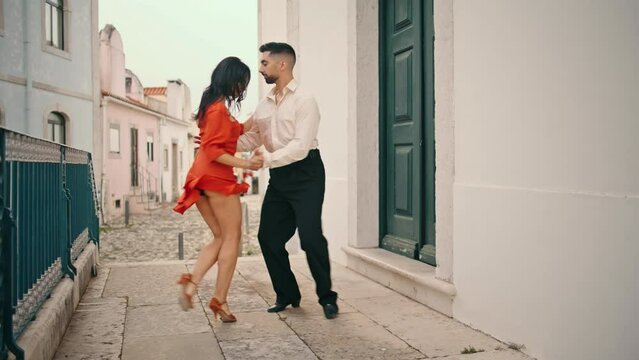 Sensual dancers performing latin american style on city street. Couple dancing 