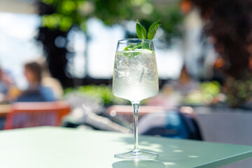 Summer refreshing lemonade drink or alcoholic cocktail with ice.  spritz cocktail on summer terrace